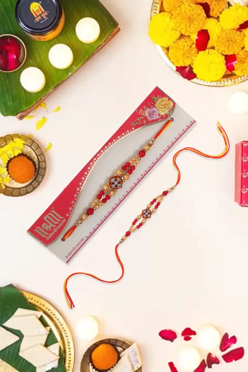 Golden & Red Beaded Rakhi with Floral Centerpiece